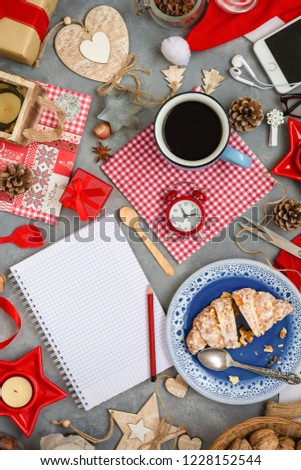 Christmas decorations and notebook with wish list on dark background. Flat lay style. Top view. Planning concept