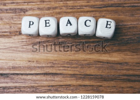 the word peace is written in wooden letters