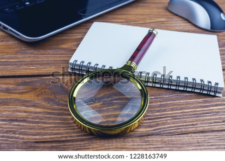 

Office Stuffs with Magnifying Glass on White Table