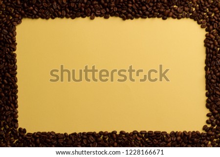 Rich yellow contrasting frame of coffee beans with a rounded upper right corner. Top view. Preparation for the inscriptions of the best selected coffee beans. Bright yellow background for ideas. Royalty-Free Stock Photo #1228166671