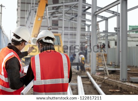 two foreman discussion on construction site