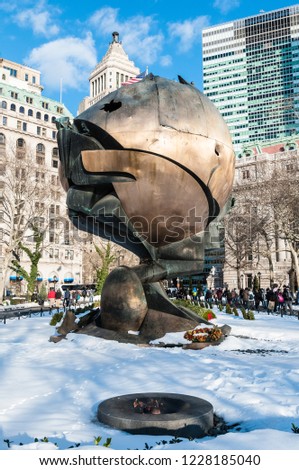 NEW YORK, UNITED STATES - DECEMBER 21, 2009: The Sphere, which once stood at the center of the plaza of the World Trade Center now temporary reinstalled Battery Park in New York, United States.