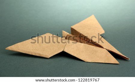 Origami butterfly on grey background