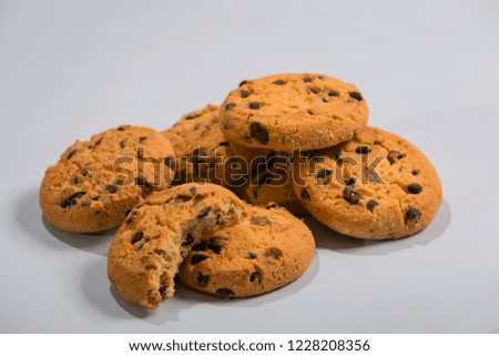 Oatmeal cookies with chocolate pieces are set on a white background.