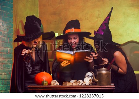Picture of three witches with book of predictions in hands