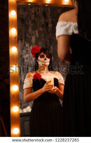 Grim halloween image of zombie girl with white face