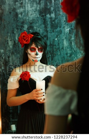 Image of witch woman with white face and red flower on her head