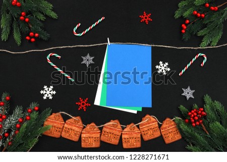 Merry Christmas and Happy New Year decoration. Space for text. Snowflakes, biscuits, fir branch.