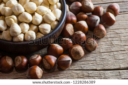 Hazelnuts, filbert  in bowl on wooden table. heap or stack of hazelnuts. Hazelnut background, healty food