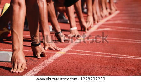 Cropped image of a sprinter getting ready to start at the stadium Royalty-Free Stock Photo #1228292239