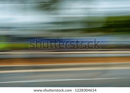 A blurred pan of a roadway.