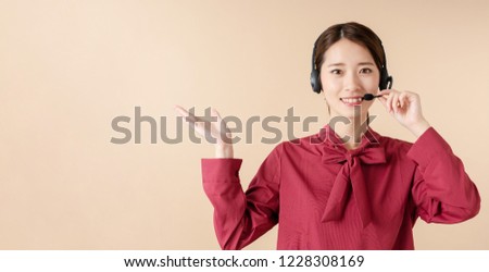 Young female operator pointing at copy space.