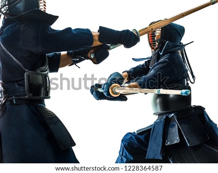 two Kendo martial arts fighters combat fighting in silhouette isolated on white bacground Royalty-Free Stock Photo #1228364587