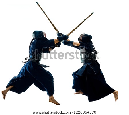 two Kendo martial arts fighters combat fighting in silhouette isolated on white bacground Royalty-Free Stock Photo #1228364590