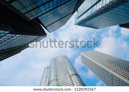 Skyscraper buildings for business and finance with reflection of blue sky