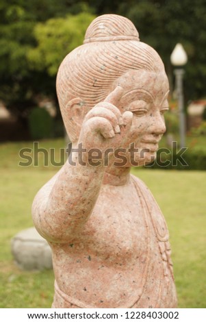 Statue of child buddha made from brown mable