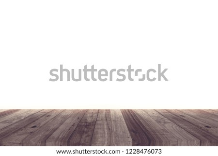A picture of a wooden desk in front of an abstract background of white.