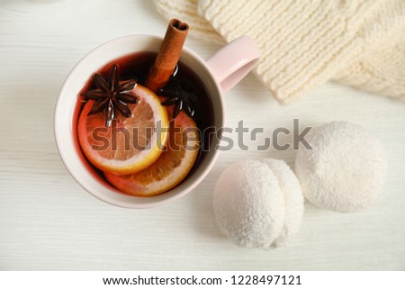 Flat lay composition with cup of hot winter drink on wooden background. Cozy season