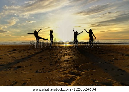 Group of women standing on the beach with the shadow morning. A wonderful holiday with the blue sky 
 and white clouds background. Good time with friends. Silhouette image.