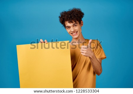 man with an orange sheet of paper, thumb             