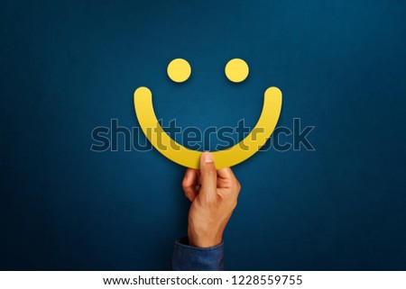Hand of client show a feedback with smiling face sign. Service rating, satisfaction concept Royalty-Free Stock Photo #1228559755