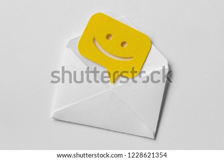 Email envelope with smiling message bubble on white background