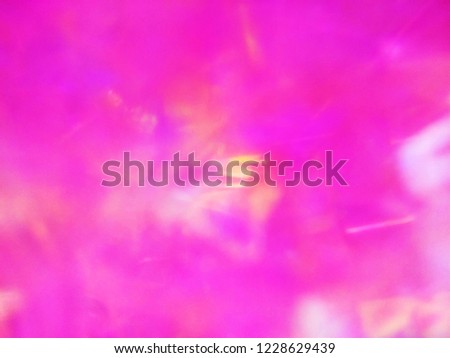 Abstract out of focus lights coming from the Closeup of Colorful Glass Globe. The Depiction of Infrared radiation of Galactic space and Universe after Big Bang. Abstract background of Red,Yellow, Blue
