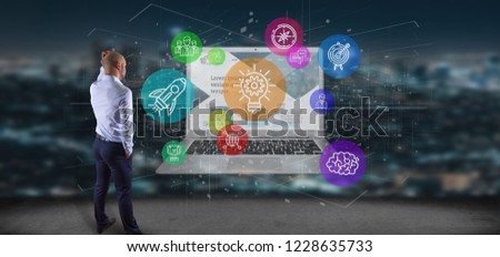 View of a Businessman in front of a Cloud of colorfull start up icon bubble with a laptop 3d rendering