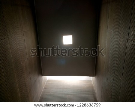 square darkness room modern style decoration with the lighting over head.