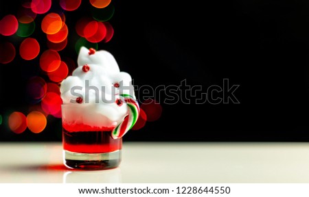 Christmas drink shot in a shot glass on a bokeh background, Christmas decoration on the bar, xmas party