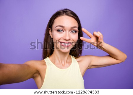 Self-portrait of nice cute sweet delicate lovely adorable charming attractive winsome brunette straight-haired girl showing v-sign near eye isolated over violet purple background
