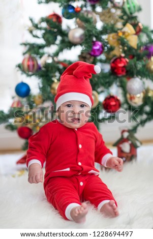 little baby dresed up as santa claus