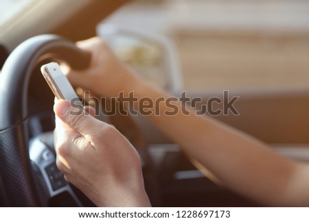 people man using smart phone mobile phone in car while driving.