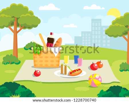 Summer picnic on forest background. Family concept with picnic party stuff. Straw basket, wine and food for outing on public park
