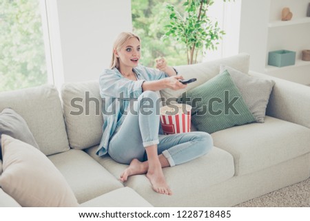 Reality show comedy she her concept. Funky excited ecstatic pretty charming lovely glad nice beautiful attractive dreamy girlish lady enjoying holiday hold remote control in hand