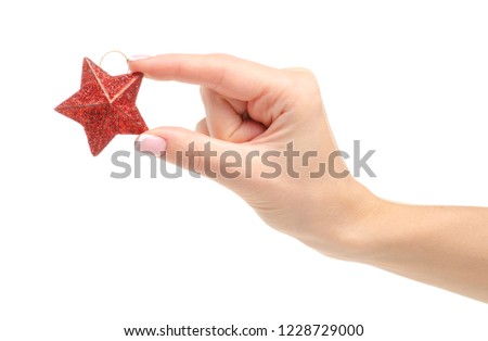 Christmas toy red star in hand on a white background. Isolation