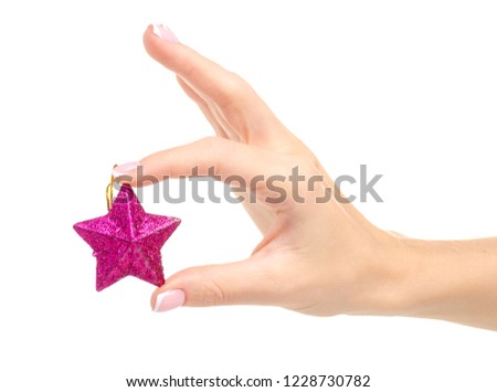 Christmas toy pink star in hand on a white background. Isolation