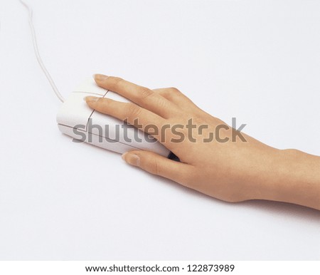 High angle view of a female hand holding optical mouse