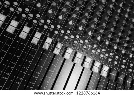 Professional Audio Sound Mixing Console Faders, black desk and white controller Faders and aux knobs