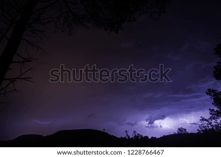 Thunderbolts over the mountains with blue and purple sky