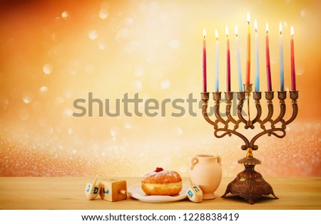 image of jewish holiday Hanukkah background with menorah (traditional candelabra) and candles over glitter shiny background