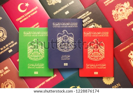 Diplomatic, official and civil passports of the United Arab Emirates against the background of various passports in many countries of the world Royalty-Free Stock Photo #1228876174