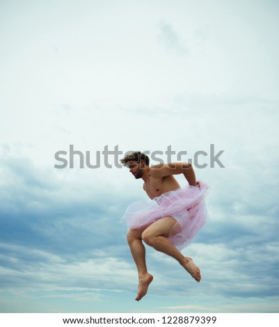 Man dancing in tutu in ballet studio. Crazy ballerina. drag queen. Man in ballerina skirt outdoor. Funny man freak. Inspiration and dreaming. sense of freedom. Man jump on sky background