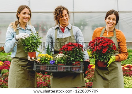 Smiling florists in greenhouse