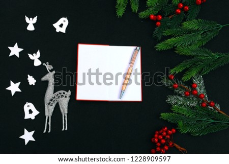 Merry Christmas and Happy New Year decoration on a black background. Text place. Stars, notepad, fir branch.