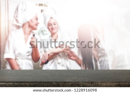 Table place of free space for your decoration and blurred background of bathroom with woman. 