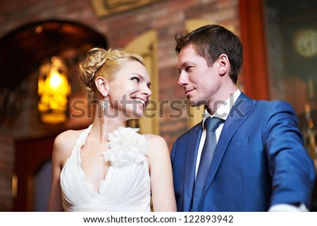 Happy bride and groom in interior