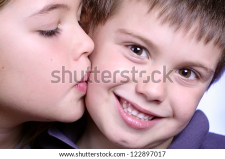 portrait of girl kissing boy