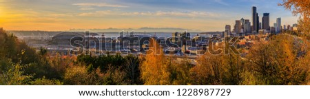 Panoramic view of Seattle downtown skyline  at sunset in the fall with yellow foliage in the foreground from Dr. Jose Rizal Park