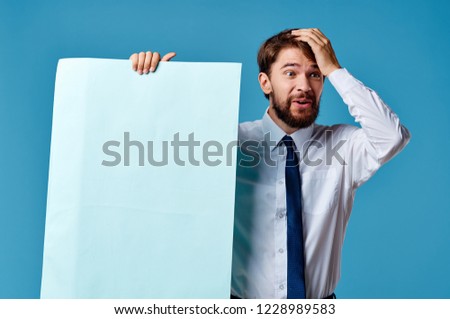 man holds his head and holds mockup                     